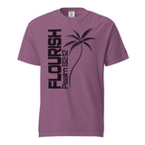 A mauve purple short-sleeve t-shirt with a black graphic print featuring the word 'FLOURISH' vertically, a palm tree, and 'PSALM 92:12' on the front, displayed on a solid white background.