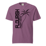 A mauve purple short-sleeve t-shirt with a black graphic print featuring the word 'FLOURISH' vertically, a palm tree, and 'PSALM 92:12' on the front, displayed on a solid white background.