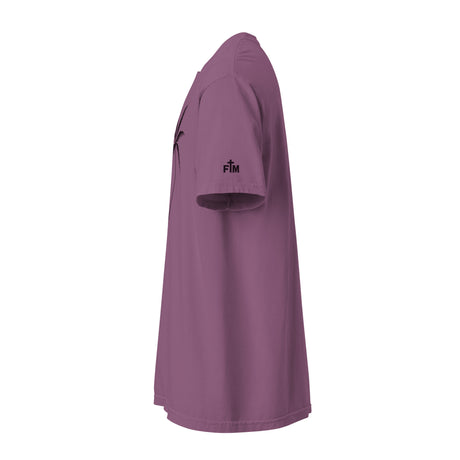 A short-sleeve t-shirt in a dusty mauve or purple color, shown from a side profile view on a solid white background. A small dark purple logo with the letters 'FM' is printed on the left sleeve. Faith Mode.