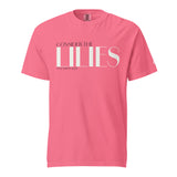 A pink short-sleeve crewneck t-shirt with a white graphic text print reading 'CONSIDER THE LILIES' and 'MATTHEW 6:28' underneath, displayed on a solid white background.
