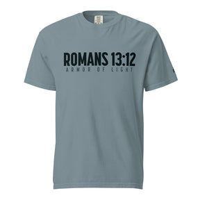 A slate blue short-sleeve t-shirt with 'ROMANS 13:12' and 'ARMOR OF LIGHT' printed in black across the chest, displayed on a clean white background.