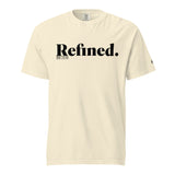 A cream-colored short-sleeve t-shirt with 'Refined.' printed in black serif font across the chest, accompanied by smaller text 'JOB 28:10' underneath, shown on a plain white background.