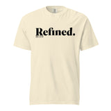 A cream-colored short-sleeve t-shirt with 'Refined.' printed in black serif font across the chest, accompanied by smaller text 'JOB 28:10' underneath, shown on a plain white background.