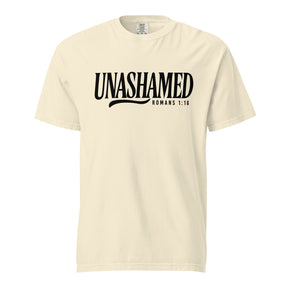 A cream-colored short-sleeve t-shirt with 'UNASHAMED ROMANS 1:16' printed in black across the chest, displayed on a solid white background.