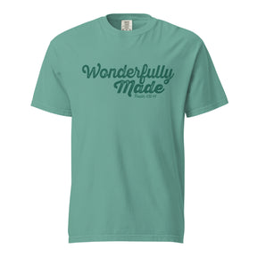A seafoam green short-sleeve crewneck t-shirt with 'Wonderfully Made' printed in dark green script across the chest, displayed on a solid white background.