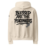 Beige hoodie with 'Blessed are the Peacemakers' text printed on the back of the hoodie in black ink.