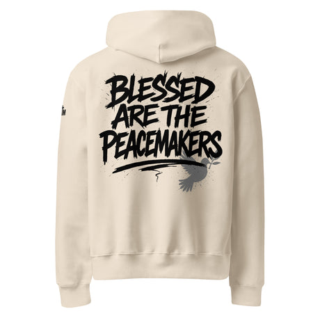 Beige hoodie with 'Blessed are the Peacemakers' text printed on the back of the hoodie in black ink.