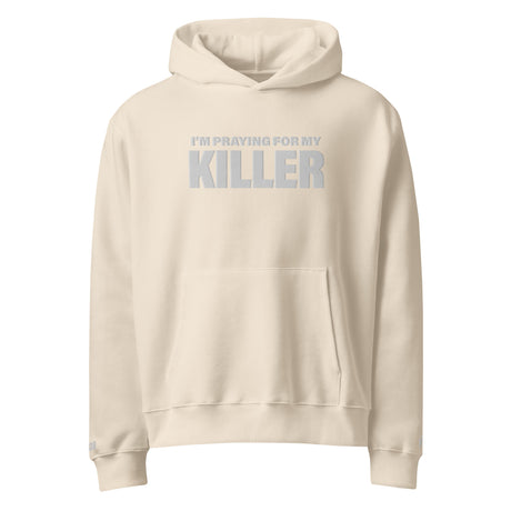 Beige hoodie with text 'I'm praying for my killer' on a white background