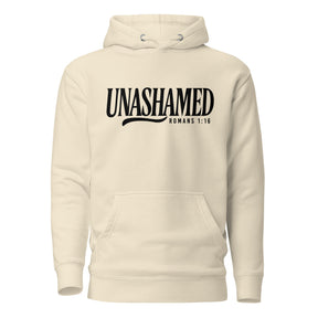 An off-white hooded sweatshirt with a black graphic print on the chest reading 'UNASHAMED' and 'ROMANS 1:16' below it, shown against a plain white background.