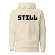 An off-white hooded sweatshirt with a black graphic print on the chest reading 'STILL PSALM 23', displayed against a solid white background.