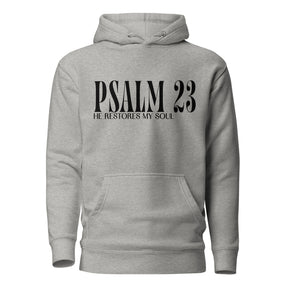 A light heather gray pullover hoodie with a black graphic print on the chest reading 'PSALM 23 HE RESTORES MY SOUL', shown against a plain white background.
