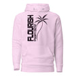 A light pink pullover hoodie with a black graphic print on the front featuring the word 'FLOURISH' vertically, 'Psalm 92:12', and a palm tree illustration.