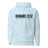 A light blue pullover hoodie with a black graphic print on the chest reading 'ROMANS 13:12' and 'ARMOR OF LIGHT'.