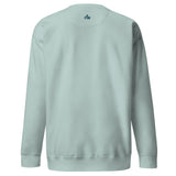 Small teal Faith Mode logo on the upper back of an agave long sleeve sweatshirt