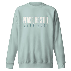 Agave blue unisex sweatshirt with cream-white “Peace, Be Still” lettering and Mark 4:39 printed beneath.