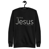 Black unisex sweatshirt with cream-white “But First, Jesus” typography and Matthew 6:33 printed on the front. Hanger view.