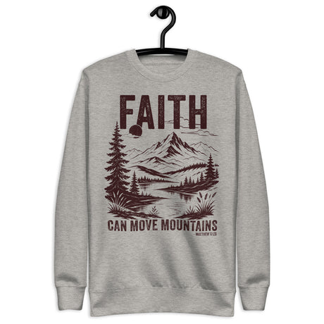 "Faith Can Move Mountains, Matthew 17:20" in maroon lettering against a carbon grey long sleeve sweatshirt, hanger view