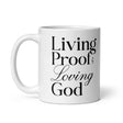 "Living Proof of a Loving God" printed in black lettering on a white glossy ceramic coffee mug