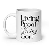 "Living Proof of a Loving God" printed in black lettering on a white glossy ceramic coffee mug