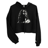 Front view of a black women’s crop hoodie with a black-and-white artistic depiction of Jesus on the chest, a drawstring hood, and long sleeves.