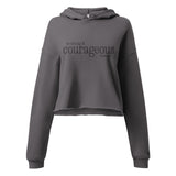 Front view of a Storm gray women’s crop hoodie with black “Be Strong and Courageous” Joshua 1:9 lettering, a drawstring hood, and long sleeves.