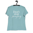 Light blue t-shirt with 'Don't stop praying' text on a hanger against a white background