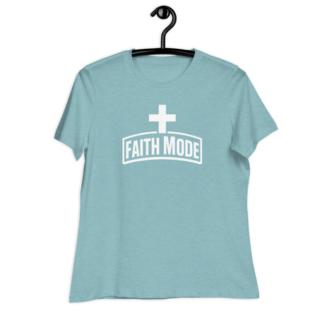 Light blue t-shirt with 'Faith Mode' text and cross on a hanger against a white background