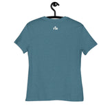 A heathered teal blue short-sleeve t-shirt hanging on a black hanger against a plain white background. The back of the shirt features a small white printed Faith Mode logo near the upper center containing the letters 'FM' and a small cross graphic between the letters.
