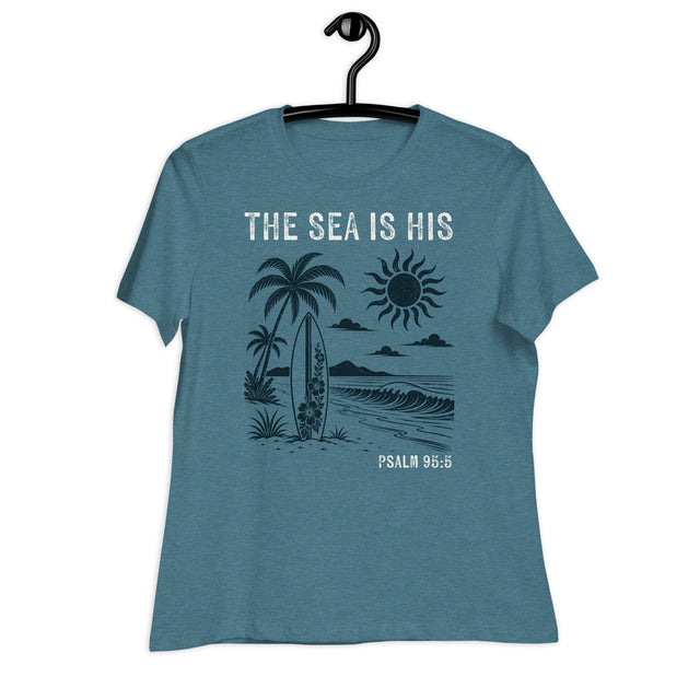 "The Sea is His" "Psalm 95:5" Printed in Cream white with a lightly distressed vintage 70s beach design in dark teal against a lighter teal women's shirt