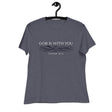 Cream white font that says "God Is With You" and under blue line designer style water accents "Isaiah 43:2" on a heather navy blue women's shirt