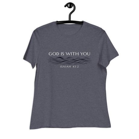 Cream white font that says "God Is With You" and under blue line designer style water accents "Isaiah 43:2" on a heather navy blue women's shirt