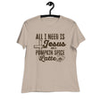 A beige short-sleeve t-shirt hanging on a black hanger against a white background, featuring a dark brown graphic print that reads 'ALL I NEED IS Jesus AND A PUMPKIN SPICE Latte' with a cross, coffee cup, and spice motif.
