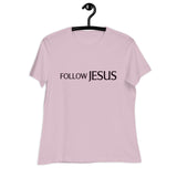 "Follow Jesus" in deep purple sans seif font across the chest of a light violet women's shirt