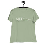 "All Things" printed in cream white ink with the scripture "Philippians 4:13" printed in dark green on a sage women's t-shirt. 