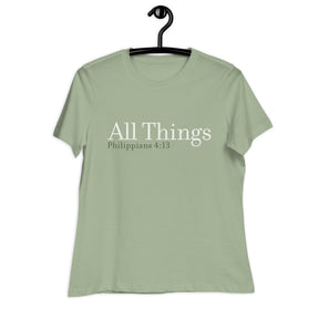 "All Things" printed in cream white ink with the scripture "Philippians 4:13" printed in dark green on a sage women's t-shirt. 